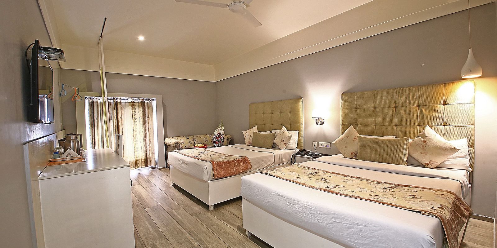 A spacious hotel room with twin beds, soft lighting, and elegant white and beige decor - Hotel Emerald, Chandigarh