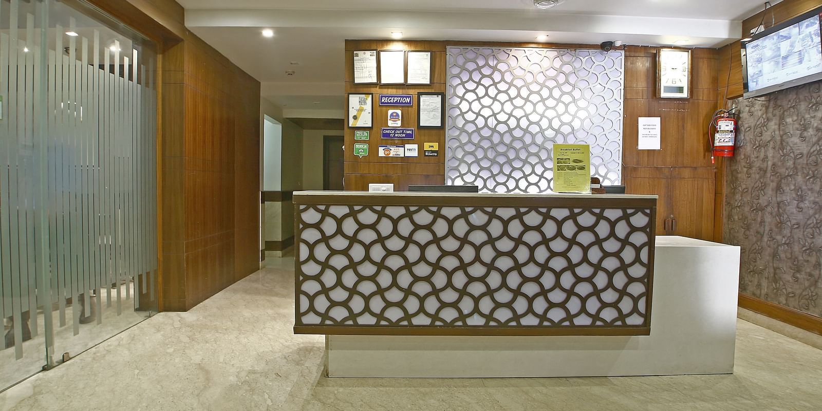 Reception desk with decorative backdrop at Hotel Emerald, Chandigarh