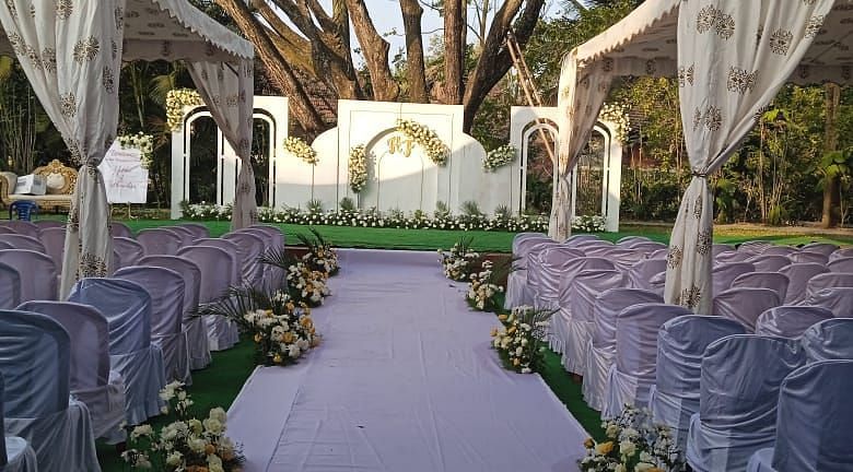 image of a wedding reception with a white pathway featuring in the middle at Hoysala Village Resort, Hassan