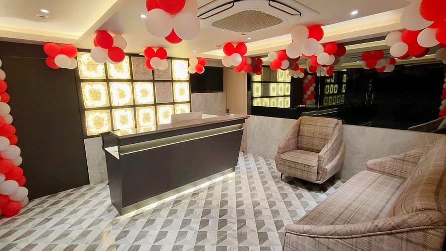Reception area with white and red balloons on the ceiling at Maxxvalue Hotel MIDC,  Mumbai
