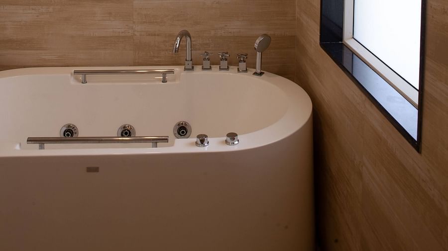 a bathtub in the washroom - Mayfair Heritage, Puri 