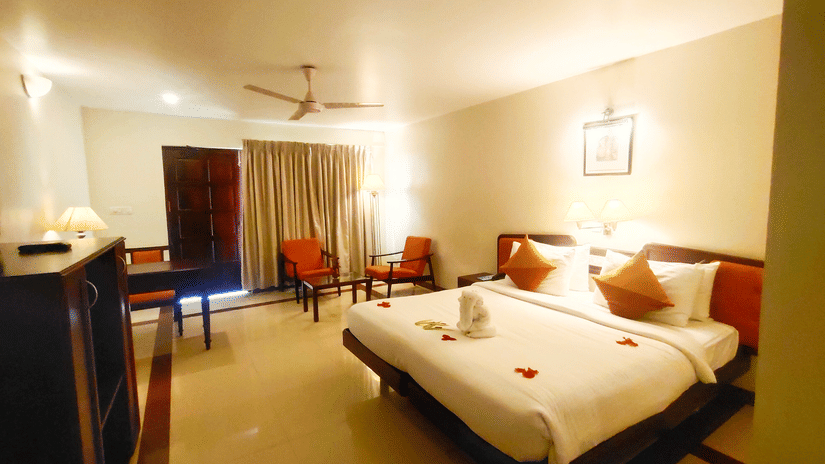 Beach Grove room with a double bed, wardrobe and seating arrangement