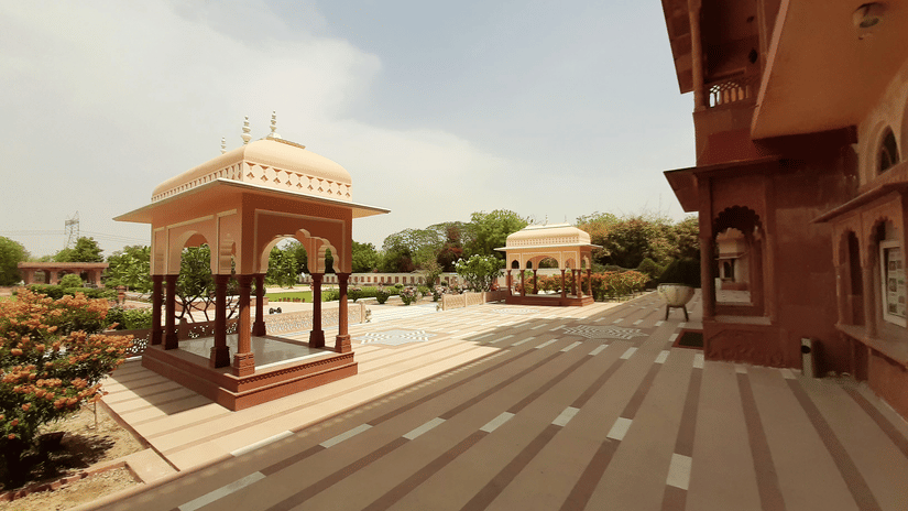 Heritage courtyard and pavilion architecture at Umaid Palace with landscaped gardens.