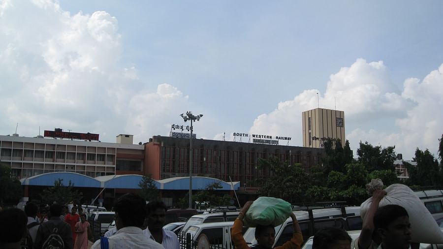 Bangalore city station with a large crowd in front of it during daytime