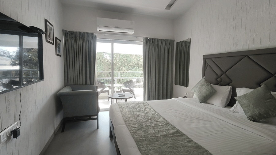 Modern bedroom with a king size bed, large windows, and elegant interiors – Maxxvalue Klub Klass Villa, Lonavala.