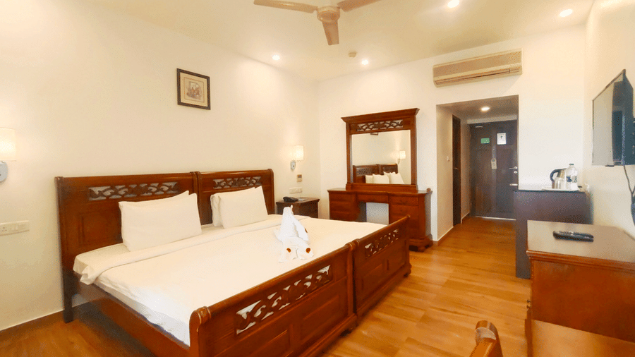 Premium mansion bedroom with a double bed, work desk and television