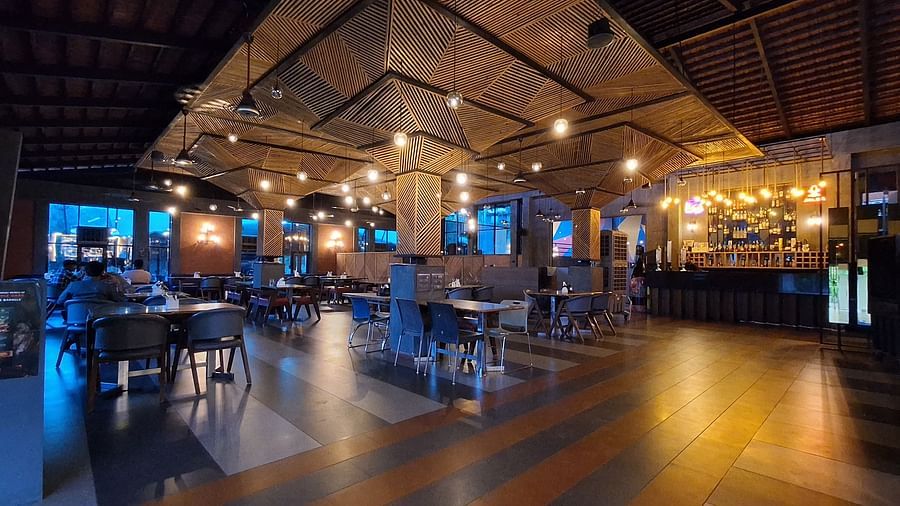 An image of Jalsa Bar featuring warm yellow ceiling lights and stylish seating arrangements at VITS Roccia Hill Resort & Adventure Park. 