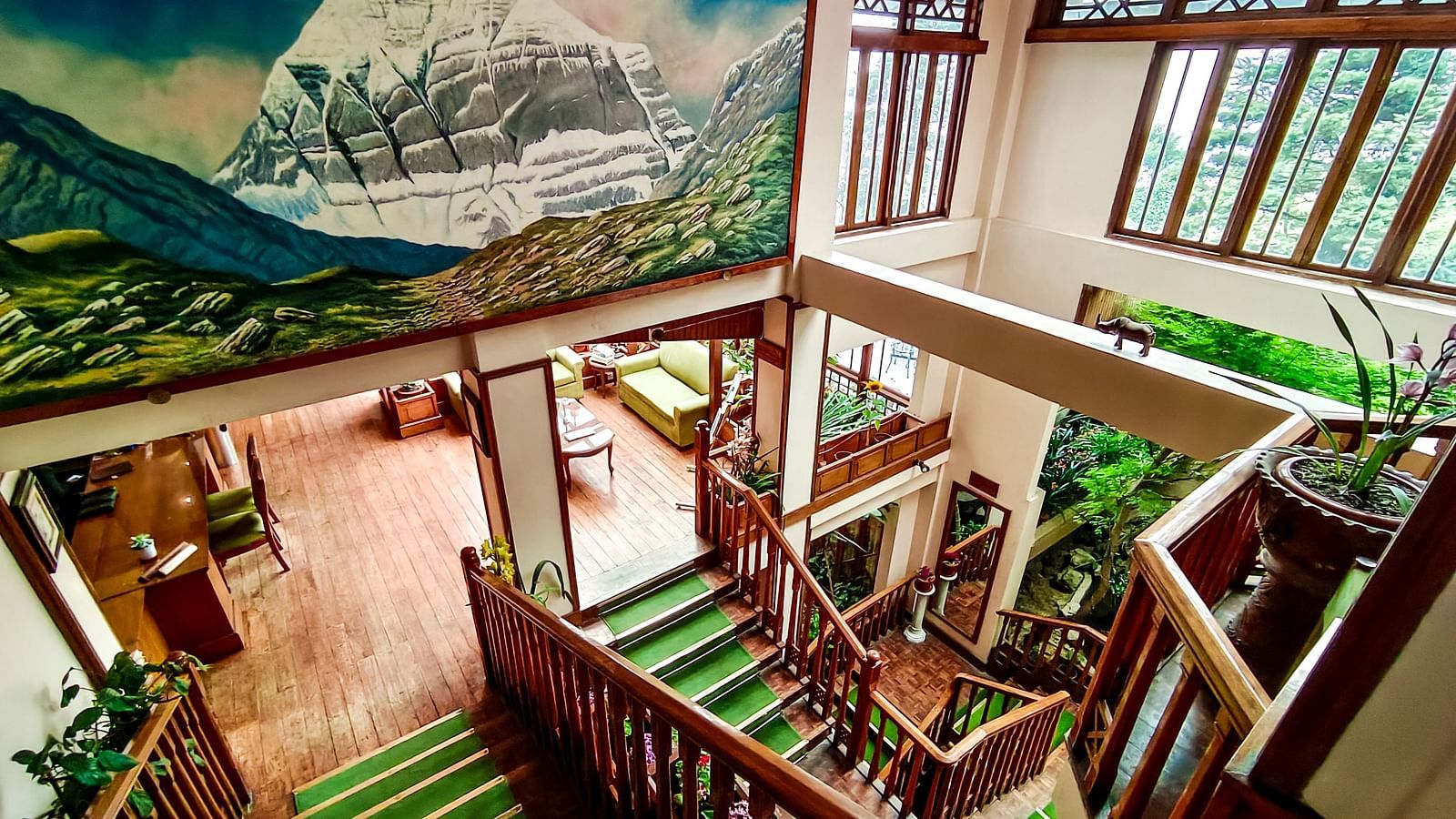 Indoor staircase and wall mural at Cedar Inn