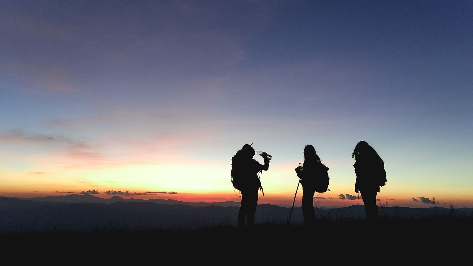 An image of three people out for trekking in the evening 