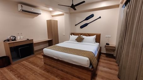 Elegant room with wooden flooring, cosy lighting, and minimal décor - Arina Island Resort, Swaraj Dweep