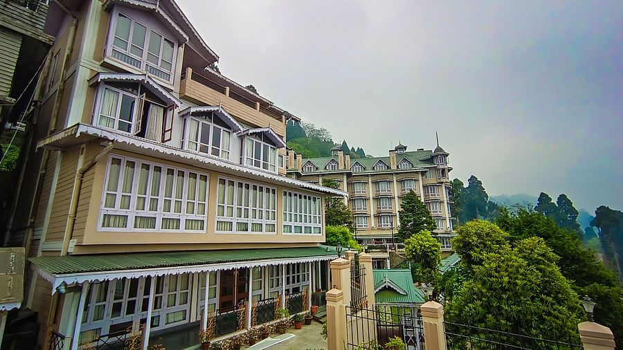 Multi-storey exterior view of Cedar Inn with lush surroundings