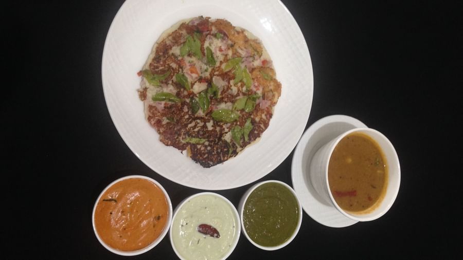 A South Indian meal featuring an uttapam, sambar, and an assortment of chutneys | Daksh The Madhuvan Suites