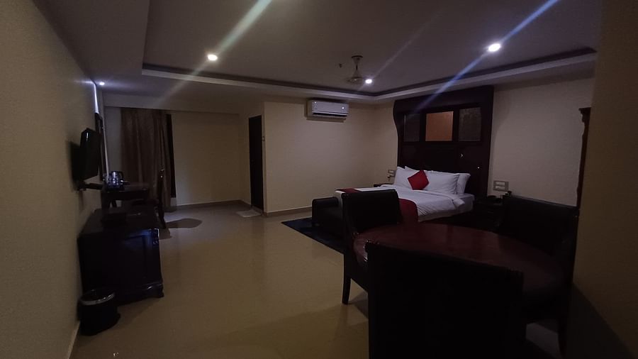 A room with bed and chairs