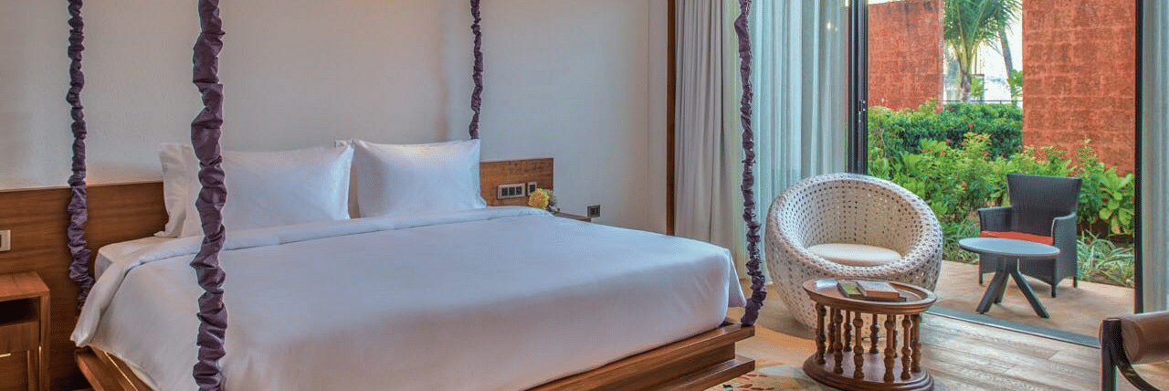 Interior of hotel room in Benaulim, Goa with decorative four-posts