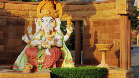 A ganesh idol placed out in the open with the sun shining down on it to signify Khajrana ganesh mandir. It is one of the best places in Indore to visit.