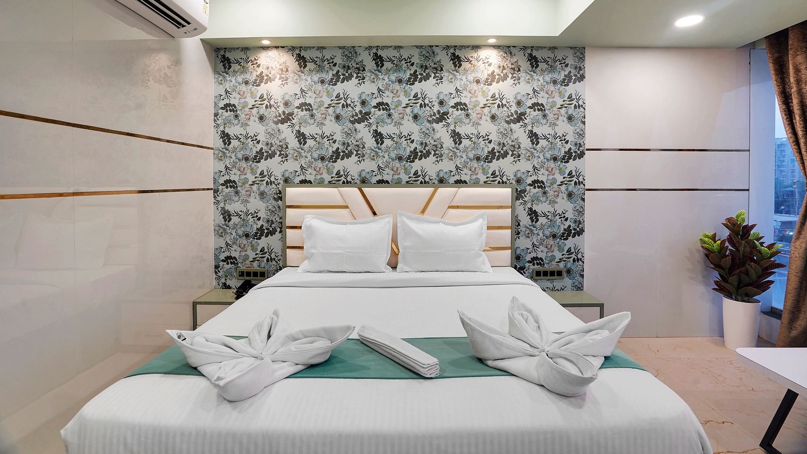 A king size bed of Deluxe Room at Hotel Regal Heaven, Pune.