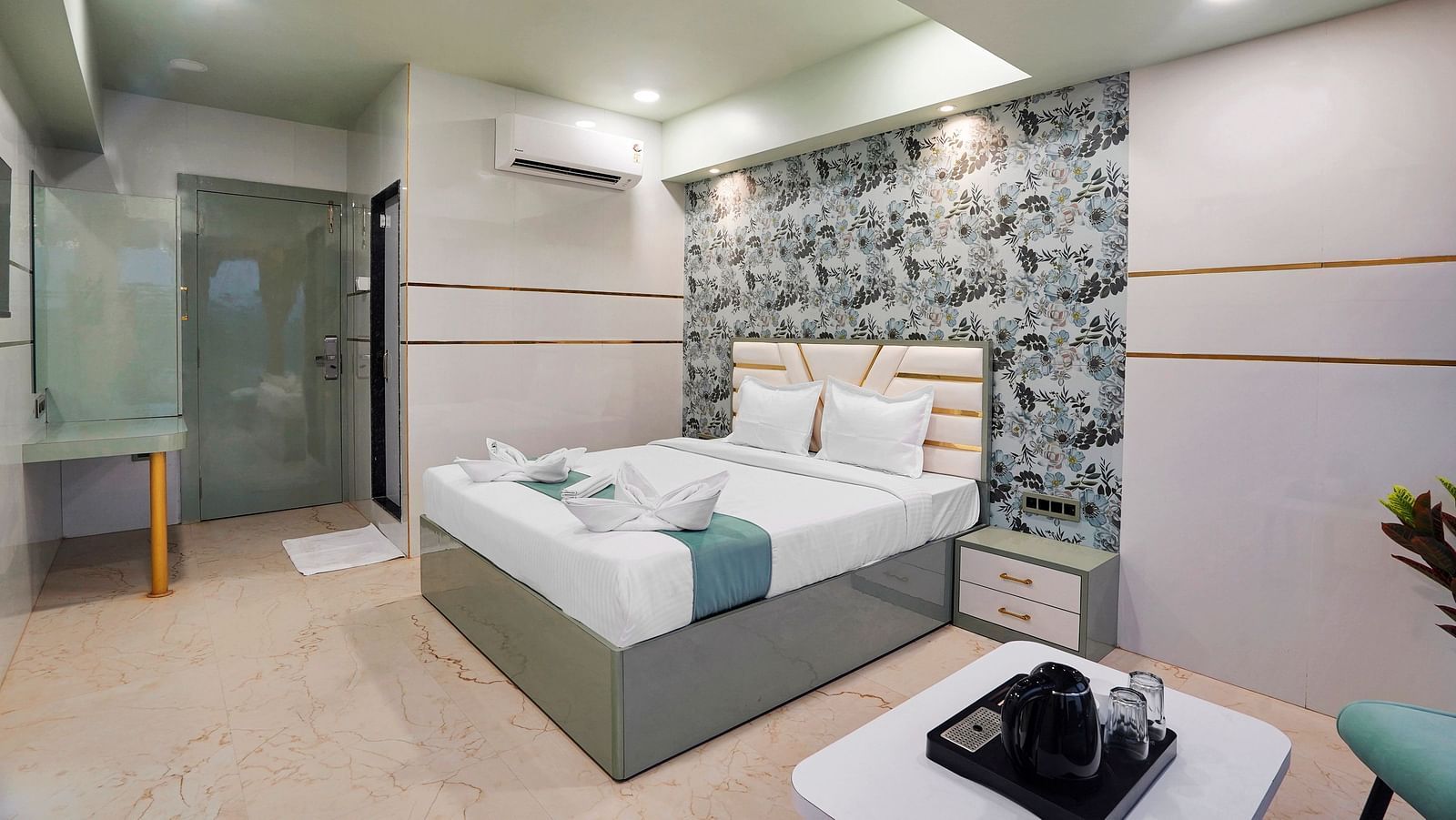 A king size bed of Deluxe Room at Hotel Regal Heaven, Pune.