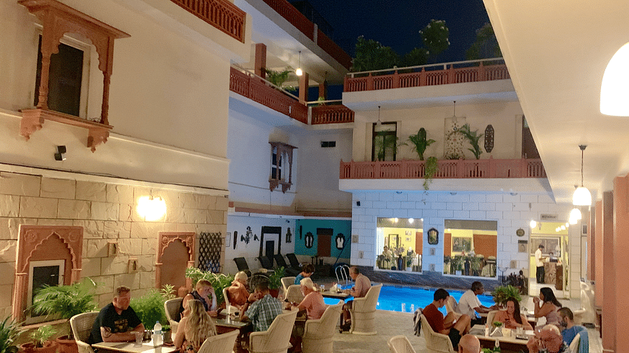 People seated at Poolside Courtyard Dining at Suryaa Villa Jaipur
