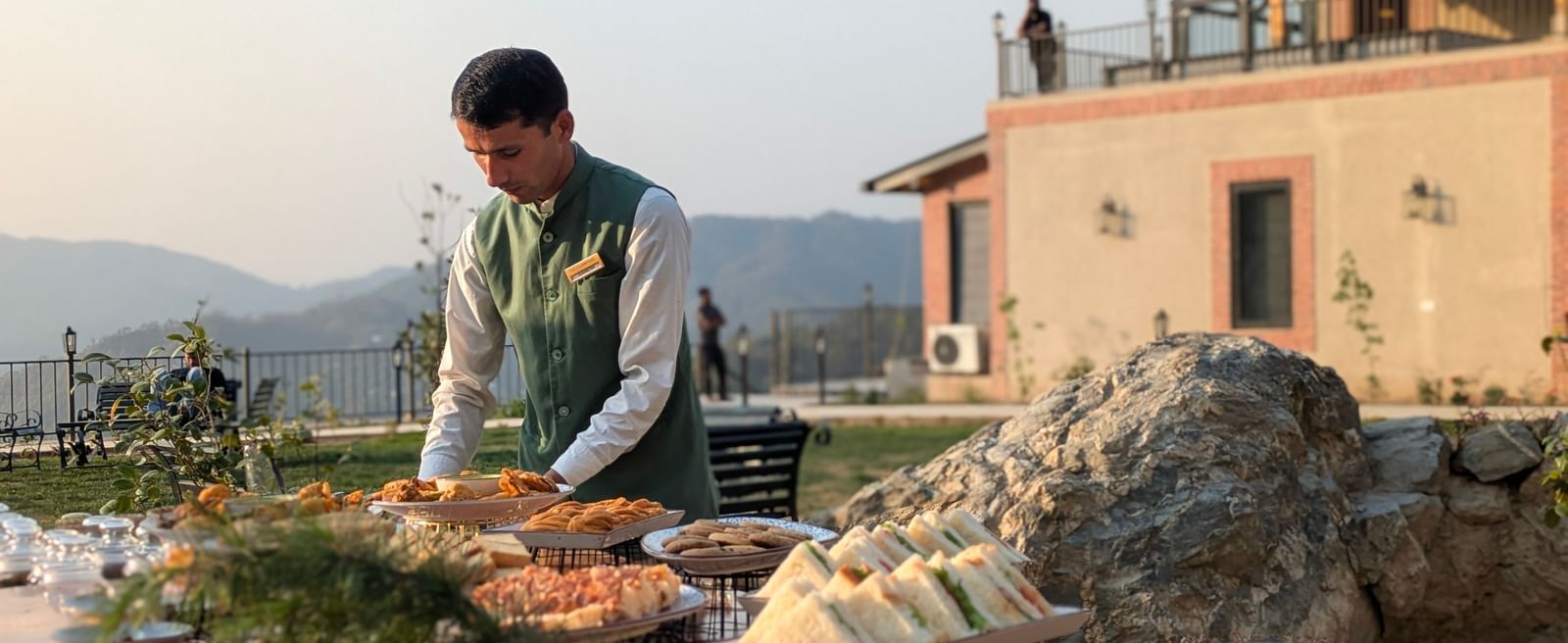 Man preparing outdoor food at a rustic mountain resort at The Chamomile Estate.