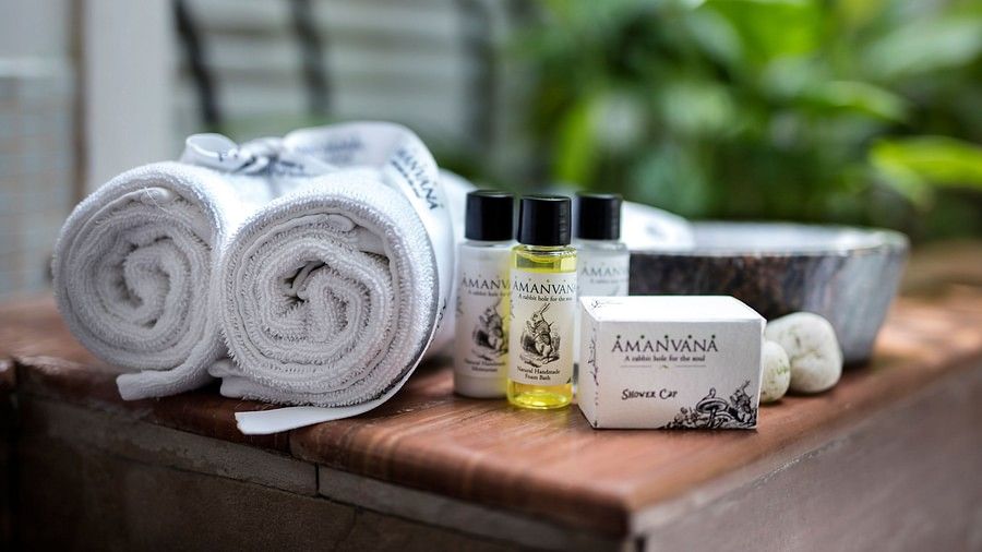 Close-up of spa essentials with towels and natural bath products.- Amanvana Resort And Spa, Resorts in Coorg 