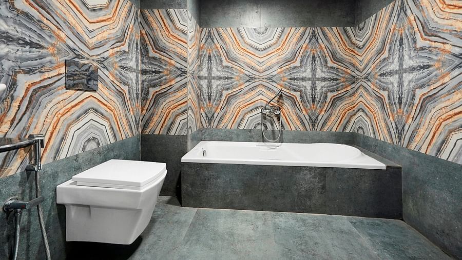 A bath tub in a washroom in Suite at Hotel Regal Heaven, Pune.