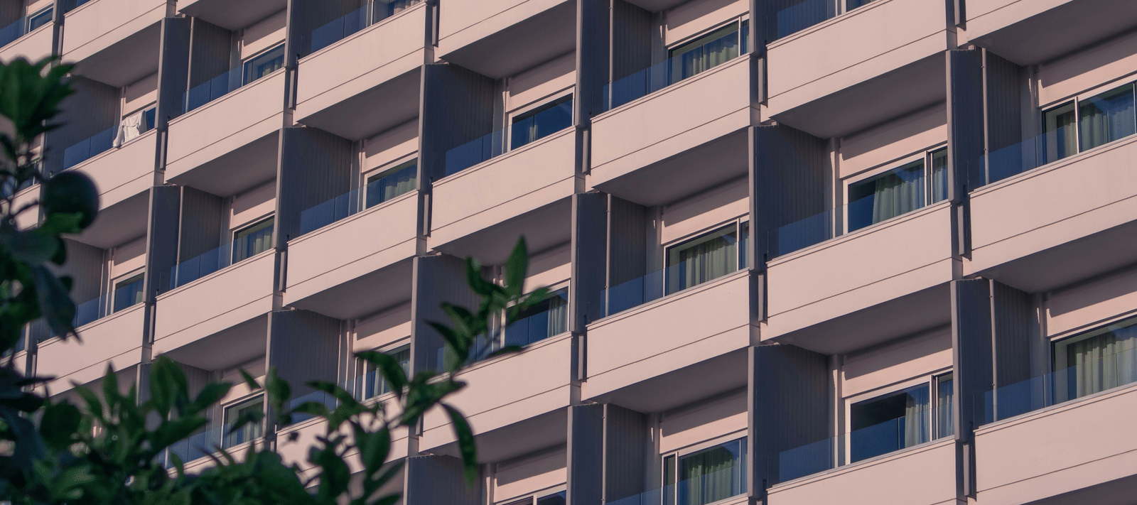 A repetitive architectural view of several identical balconies.
