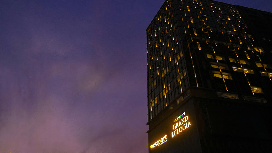 The modern facade of the hotel building illuminated at night against a twilight sky - Praveg's Grand Eulogia, Ahmedabad