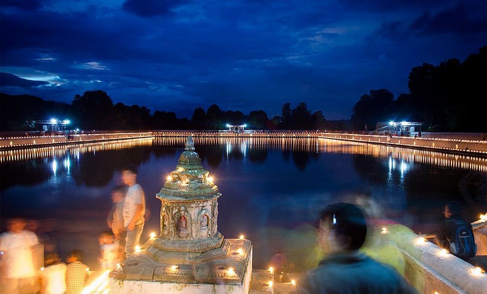 Lake view during dusk where the bank is lit with lamps