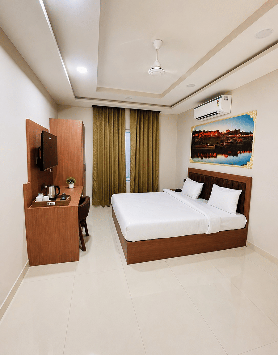Jal Mahal Classic Room double bed beside French windows with brown blackout curtains, Lime Tree Hotel & Banquet, Jaipur