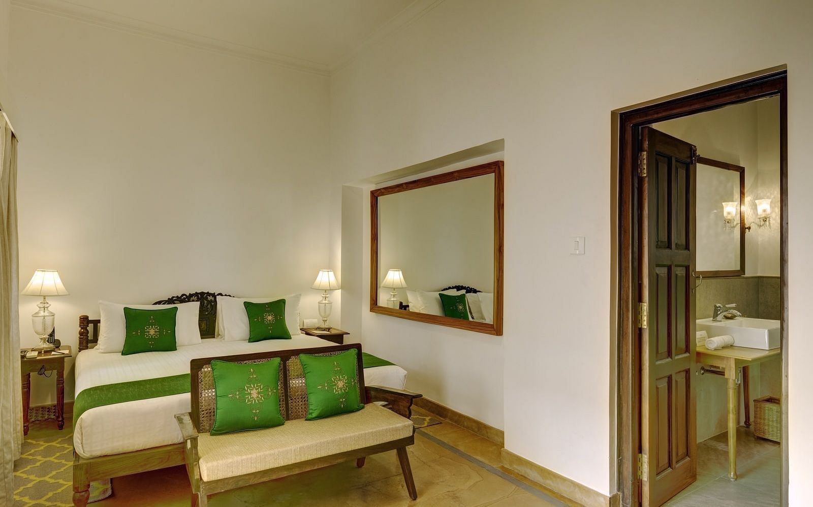 Awadh Room with a double bed and seating at Saraca Hotel, Lucknow