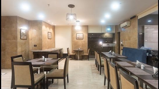 Chairs and round tables at a restaurant | Hotel Mumbai House, Andheri East