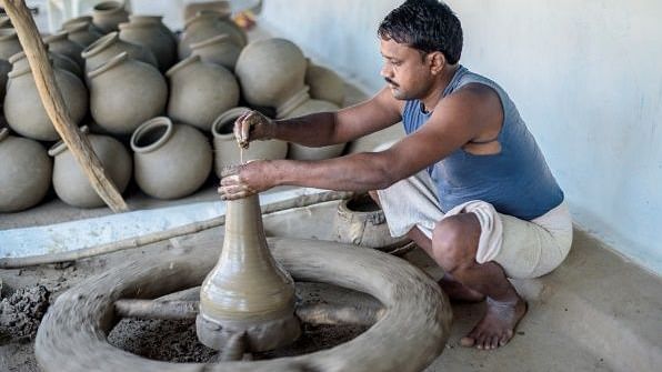 An image of a man doing pottery