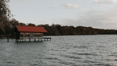 a view of a river with a boathouse