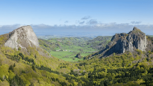scenic view of forest view with hills and blue sky in the background