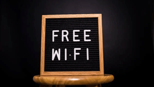 Image of a board with free wifi written on it.