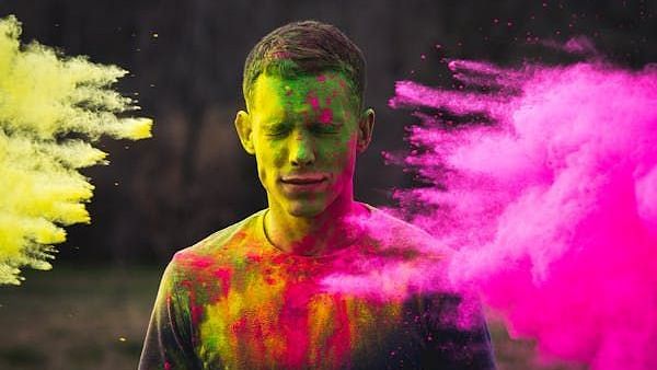A person whose face is covered with several colours.