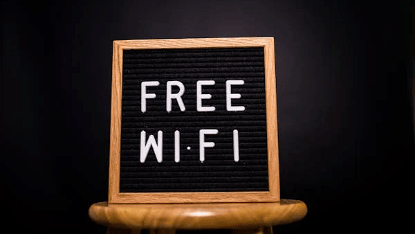 Image of a board with free wifi written on it.