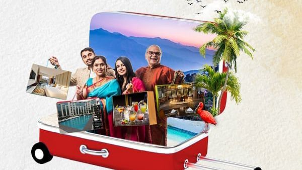 A happy Indian family standing in an open suitcase with scenic travel images, palm trees, and holiday experiences symbolising a joyful vacation.