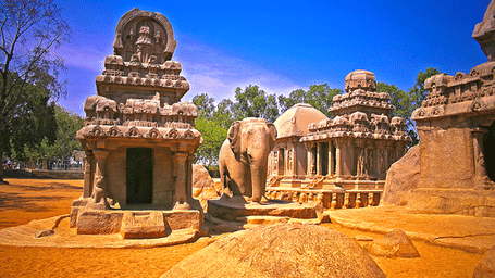 Multiple rock-cut temples with carved figures and an elephant sculpture near Hotel Mamallaa Heritage, Mahabalipuram.