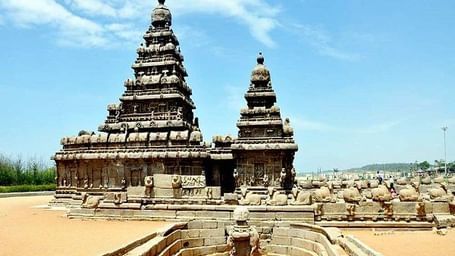 An ancient stone temple with 2 carved shrines and towers, with other carved structures, near Hotel Mamallaa Heritage, Mahabalipuram.