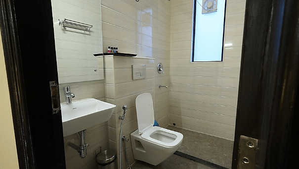 A neatly maintained washroom with white sanitary fixtures - Lime Tree Golf View, Golf Course Road
