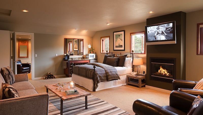 Meadowview Suite featuring a couch, a teapoy, a plush bed, a wall-mounted television and a leather couch - Brewery Gulch Inn & Spa