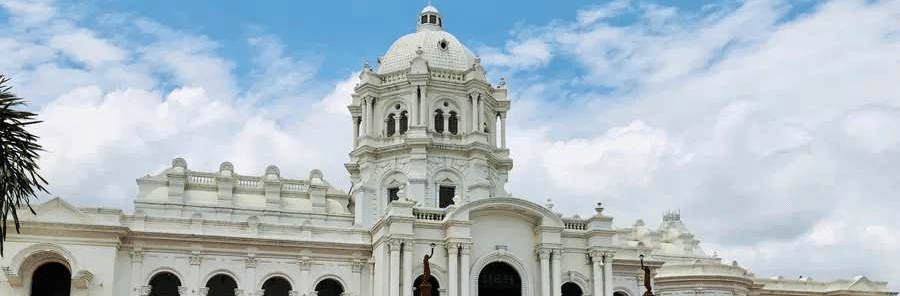 A wide shot of two-story white Ujjayanta Palace in Agartala.