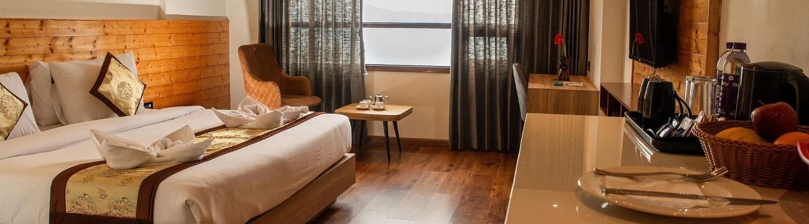 Full view shot of the Suite at Sumitel Sanderling featuring a double bed along with a window emitting plenty of natural light.