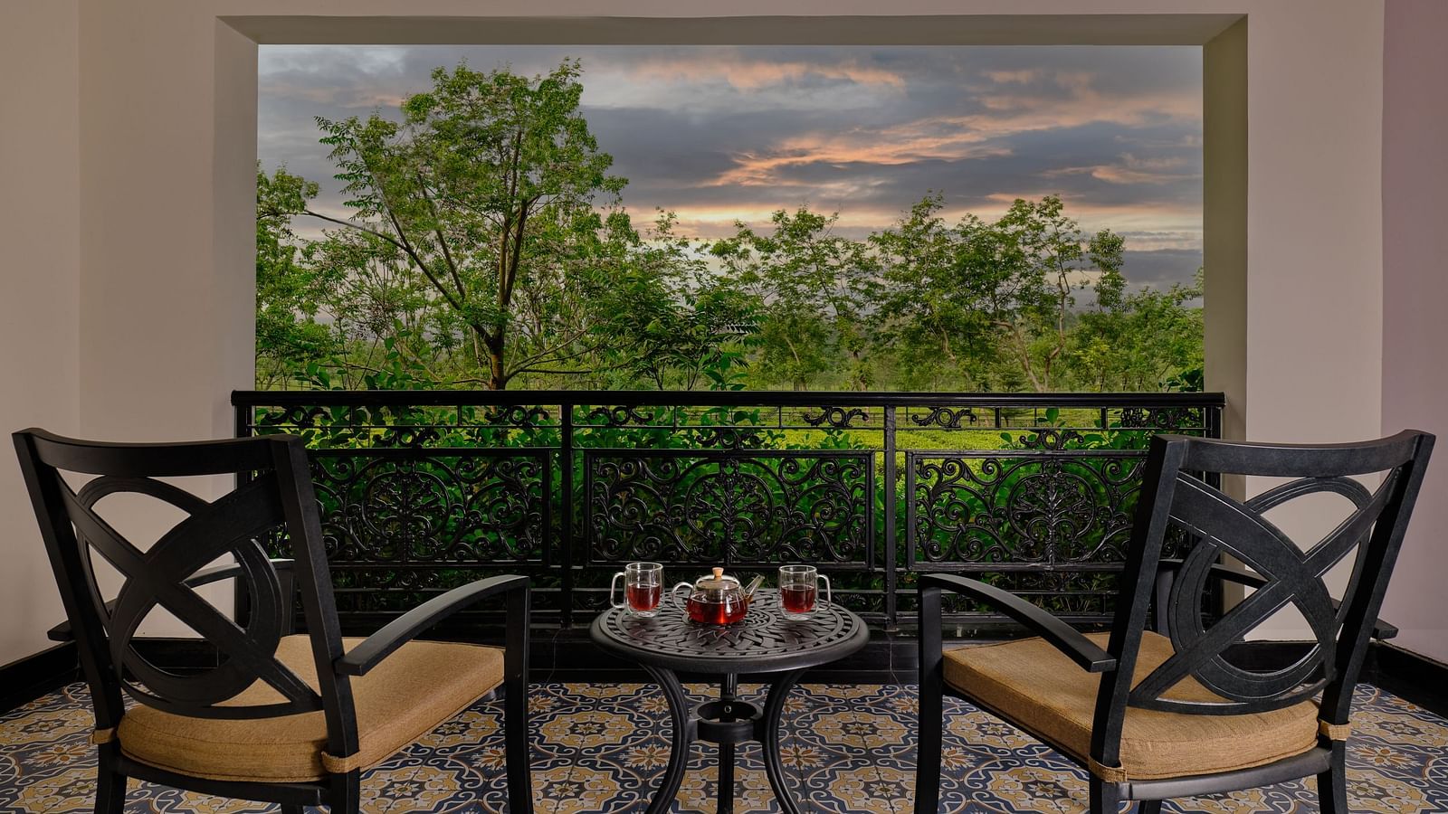 Private balcony with outdoor seating and lush greenery views at MAYFAIR Tea Resort, Siliguri