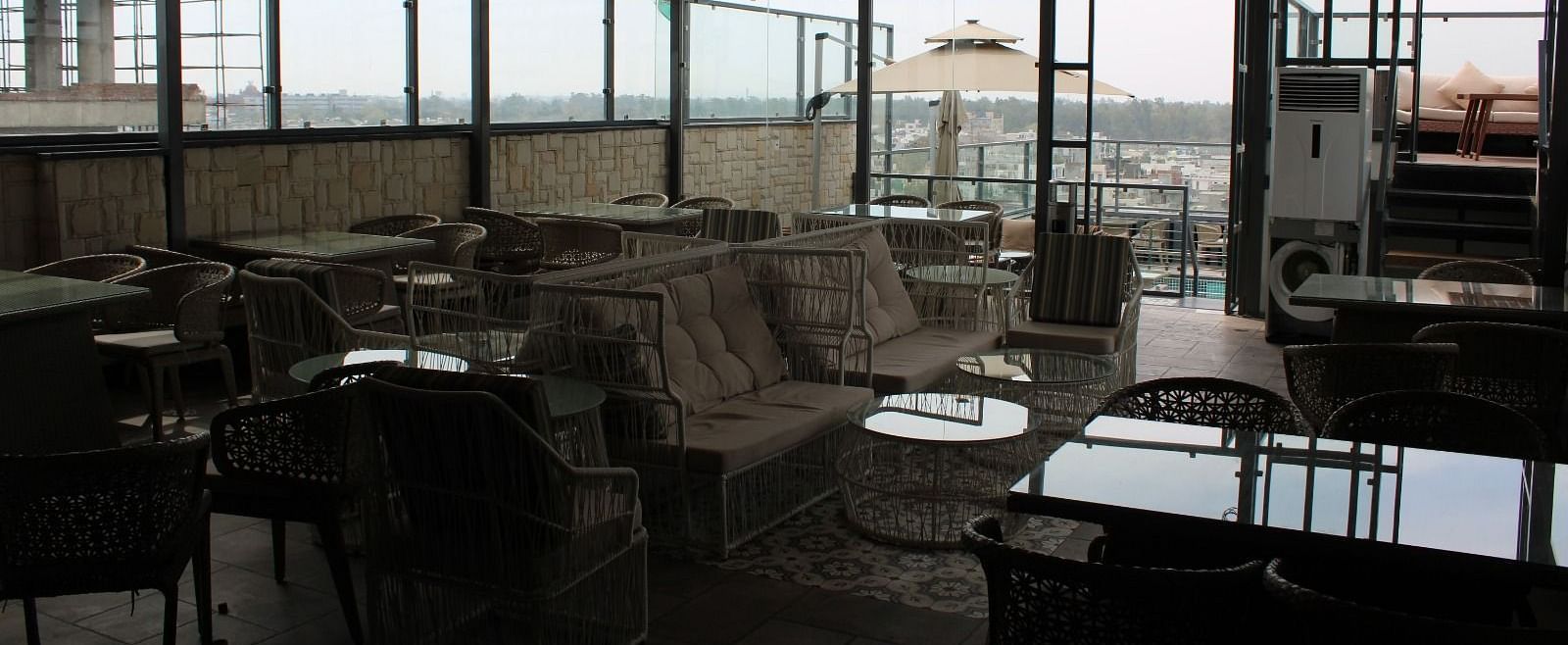 Rooftop lounge space with seating arrangements at BluSalzz Residence, Amritsar.