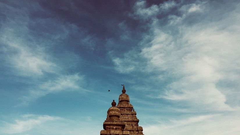 a facade image of a temple in Chennai with blue sky in the background