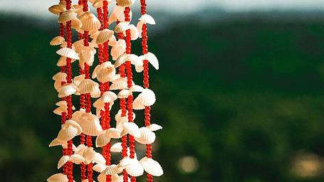 An image of a decorative pieces of shells attached with beads
