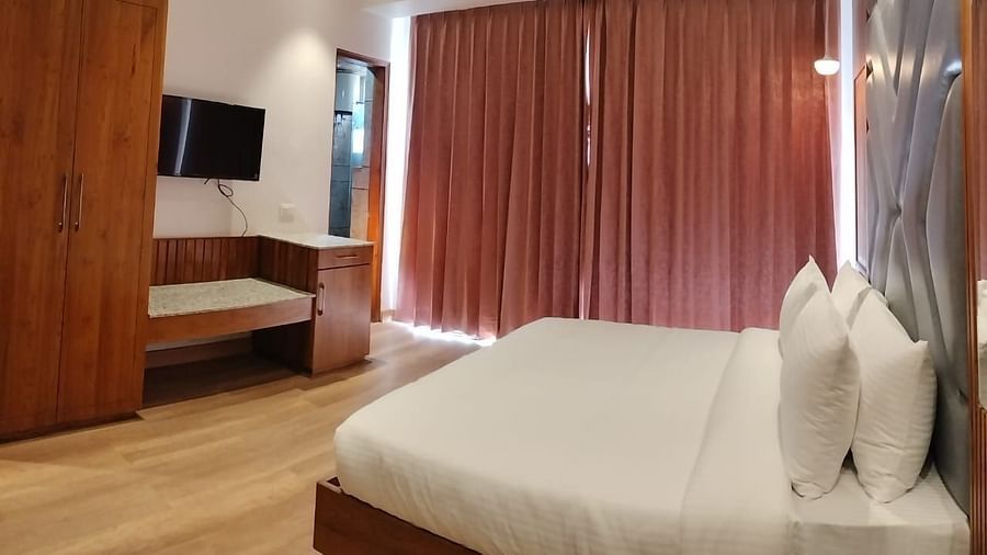 A large bed in front of the TV in Deluxe Non-view Room at DLS Ark Holiday Inn, Banikhet.