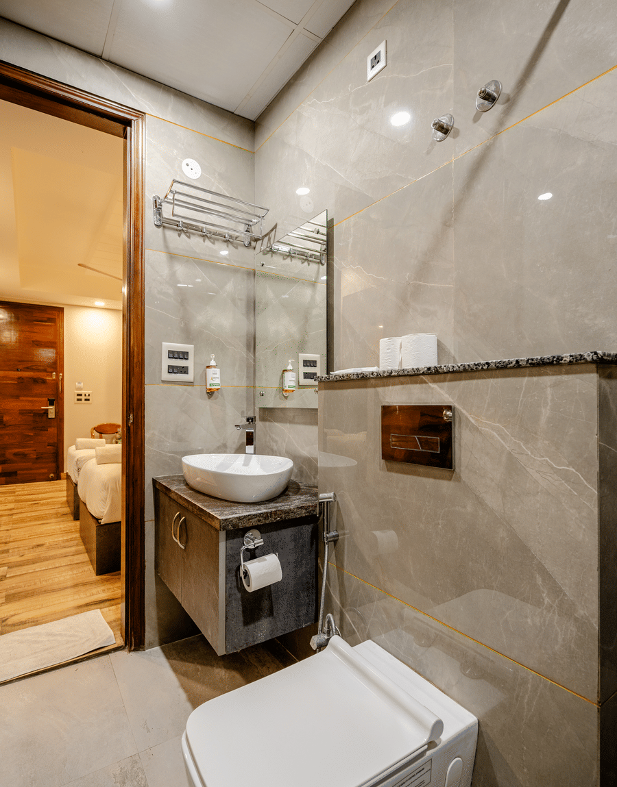 Vessel washbasin and wall-hung toilet seen from the Deluxe Twin Room doorway at Lime Tree Hotel Near Medanta